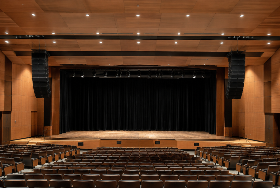 Line array speaker system installed in a large auditorium in India for even audio coverage across the seating area