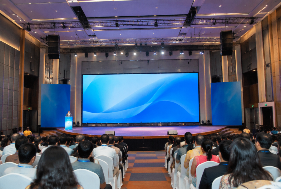 Professional auditorium AV integration in India showing a large stage display and rows of audience seating