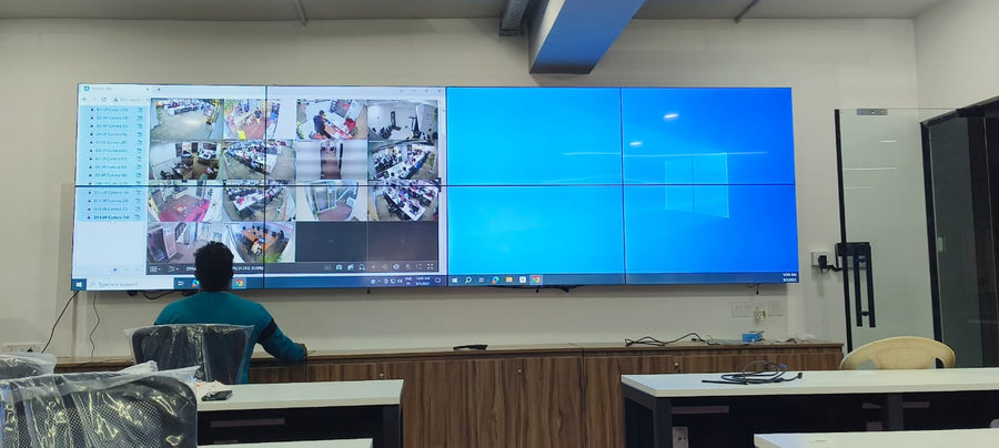 Multi-panel control room video wall in India displaying live CCTV camera feeds for continuous security and operations monitoring