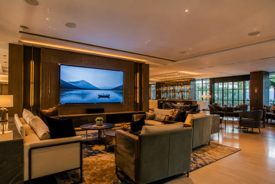 Hotel AV integration in India showing a display and audio system in a modern hotel common area