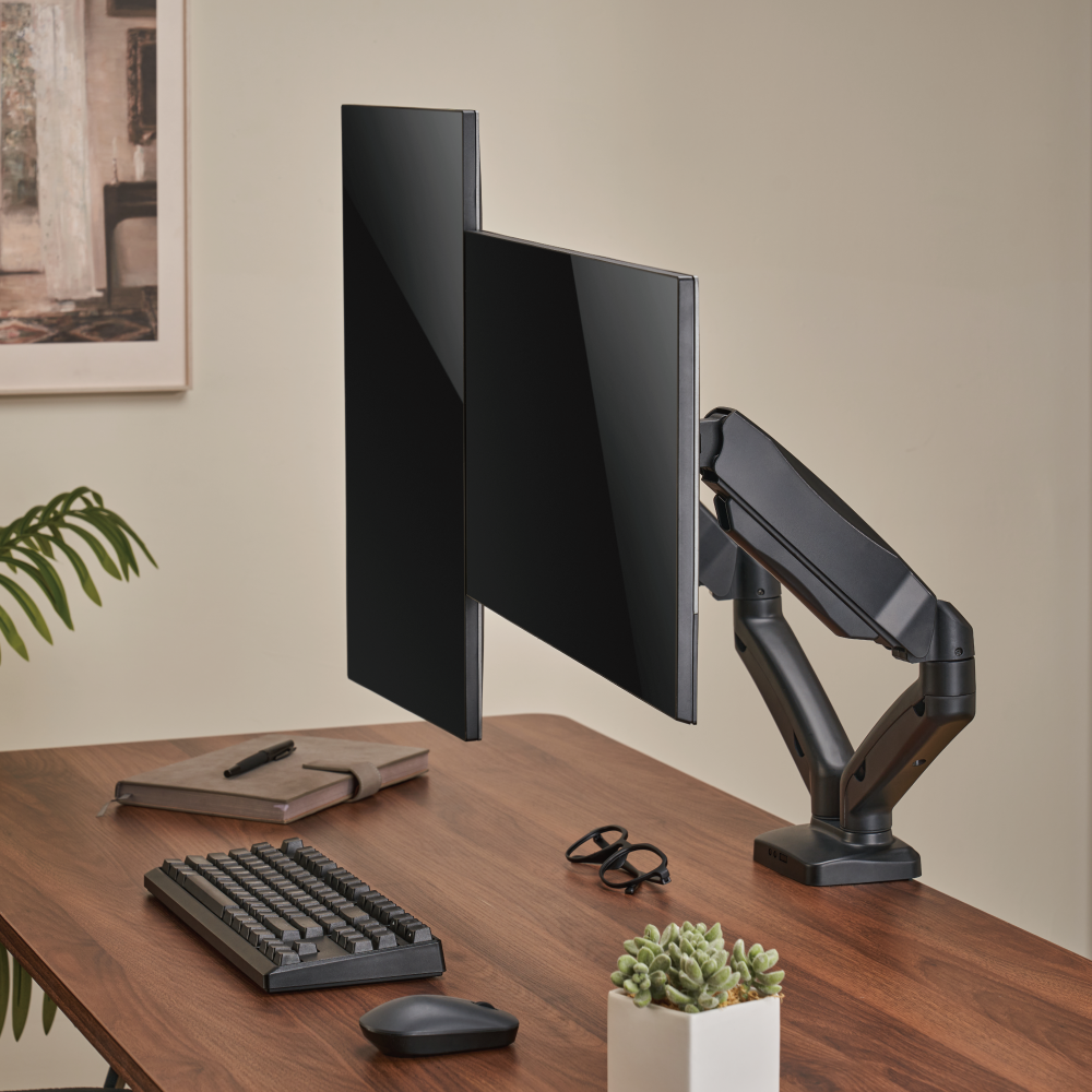 Lumi LDT13-C024E mechanical spring monitor arm installed holding a monitor on a desk in an office setup