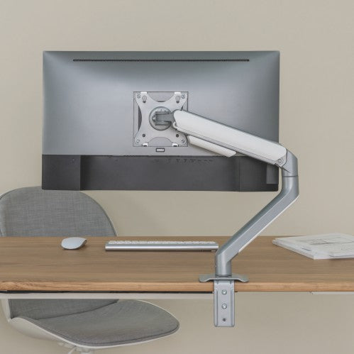 Lumi LDT63-C012 mechanical spring monitor arm installed holding a monitor on a desk in an office setup