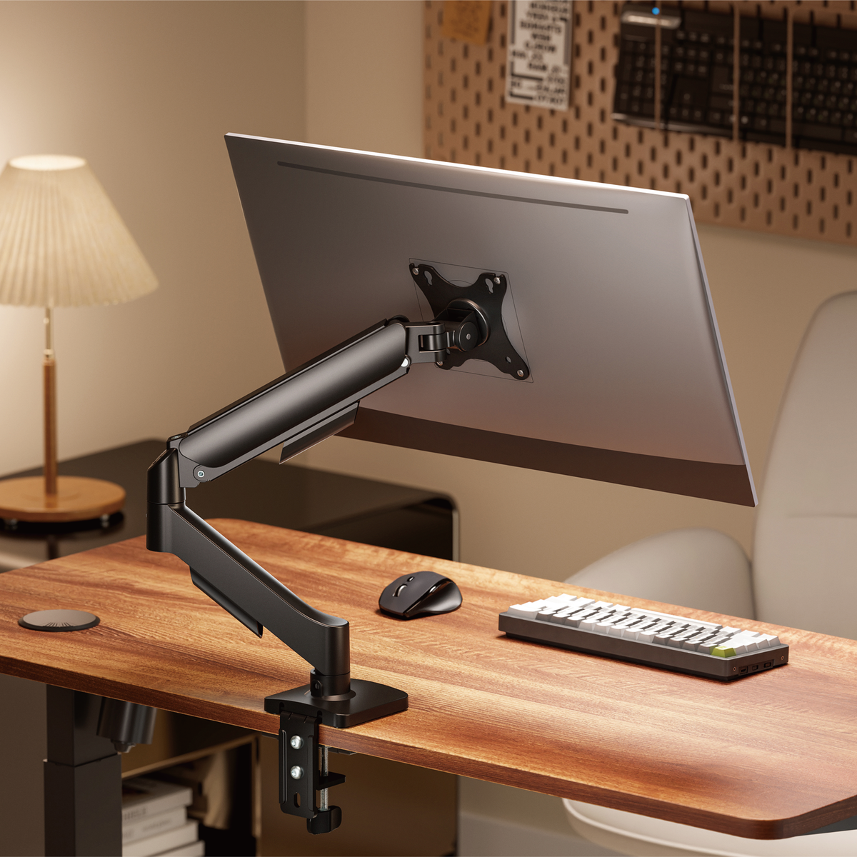 Lumi LDT97-C012 gas spring monitor arm installed holding a monitor on a desk in an office setup
