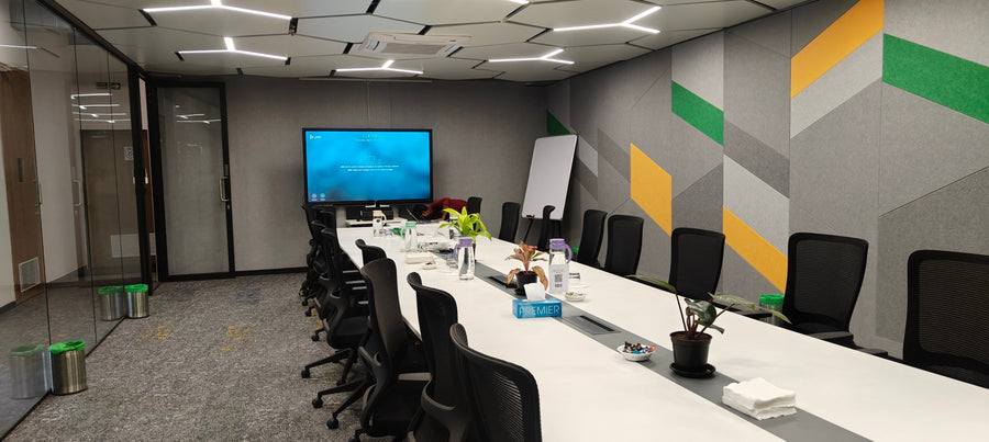 Corporate meeting room in India with a large wall-mounted display, whiteboard, and a long conference table for team collaboration